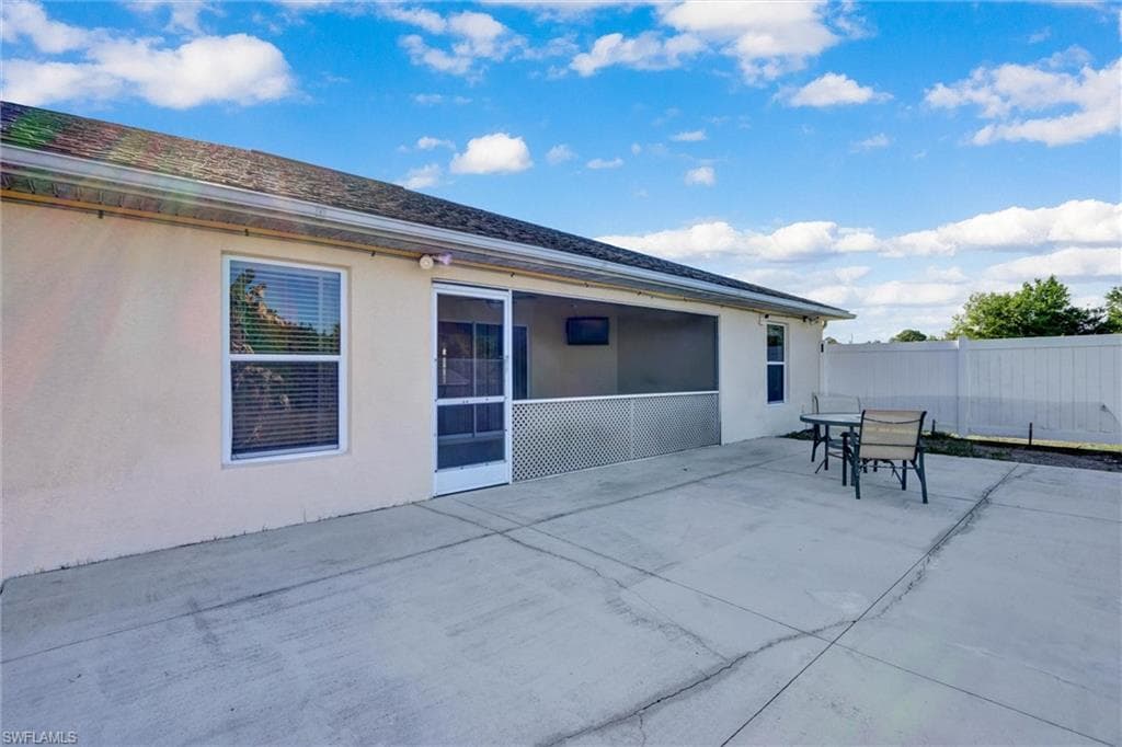 Back of house featuring stucco siding, a patio, and outdoor dining area