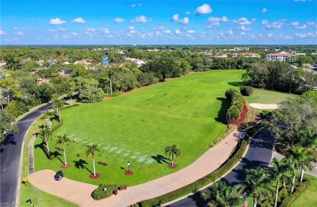 Drone / aerial view of a local golf course and a tree filled landscape