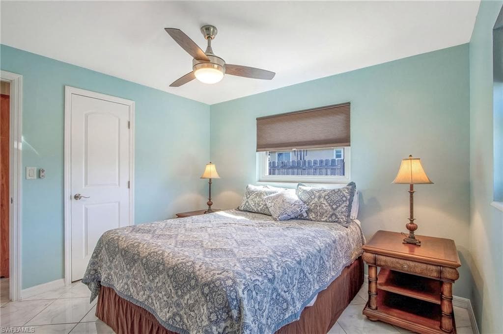 Bedroom featuring baseboards and ceiling fan