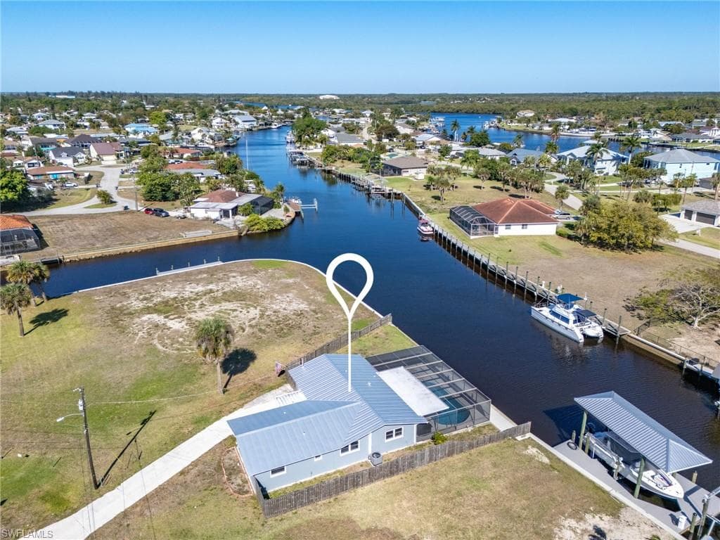 Aerial view of property's location with nearby suburban area and a nearby body of water