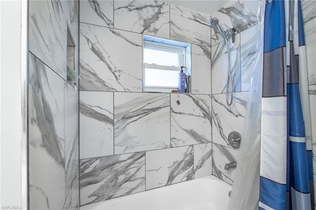 Full bathroom with shower / tub combo with curtain