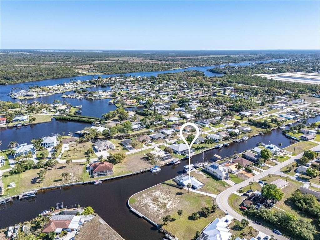 Aerial overview of property's location featuring nearby suburban area and a nearby body of water