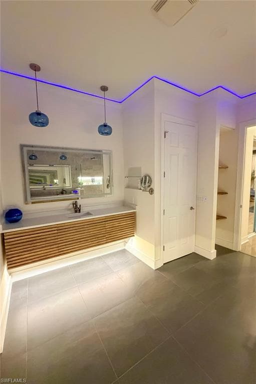 Bathroom featuring vanity and dark tile patterned floors