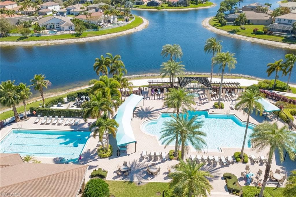 Community pool featuring a residential view, a water view, and a patio