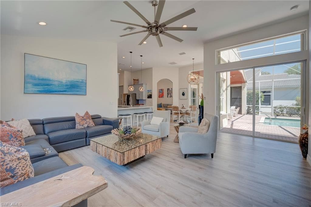 Living area featuring ceiling fan, light wood-style flooring, and recessed lighting