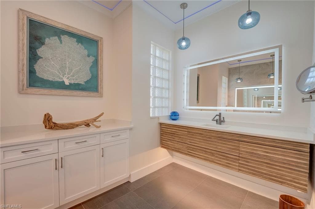 Full bathroom with vanity and dark tile patterned flooring