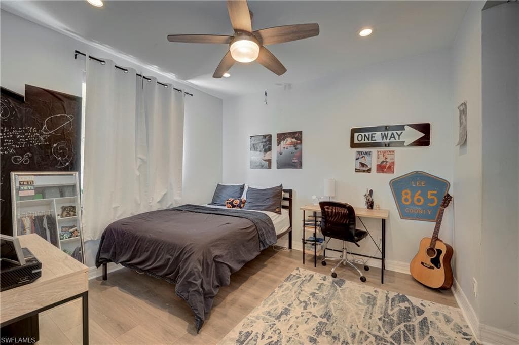 Bedroom with recessed lighting, light wood-style flooring, an office area, and ceiling fan