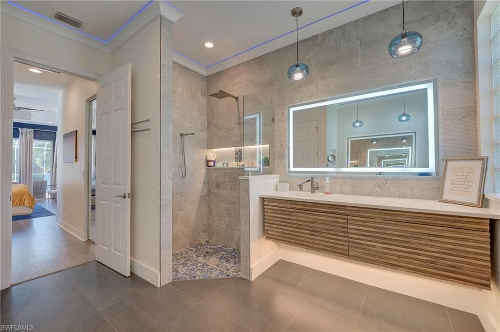Bathroom with vanity, walk in shower, crown molding, ensuite bathroom, and recessed lighting