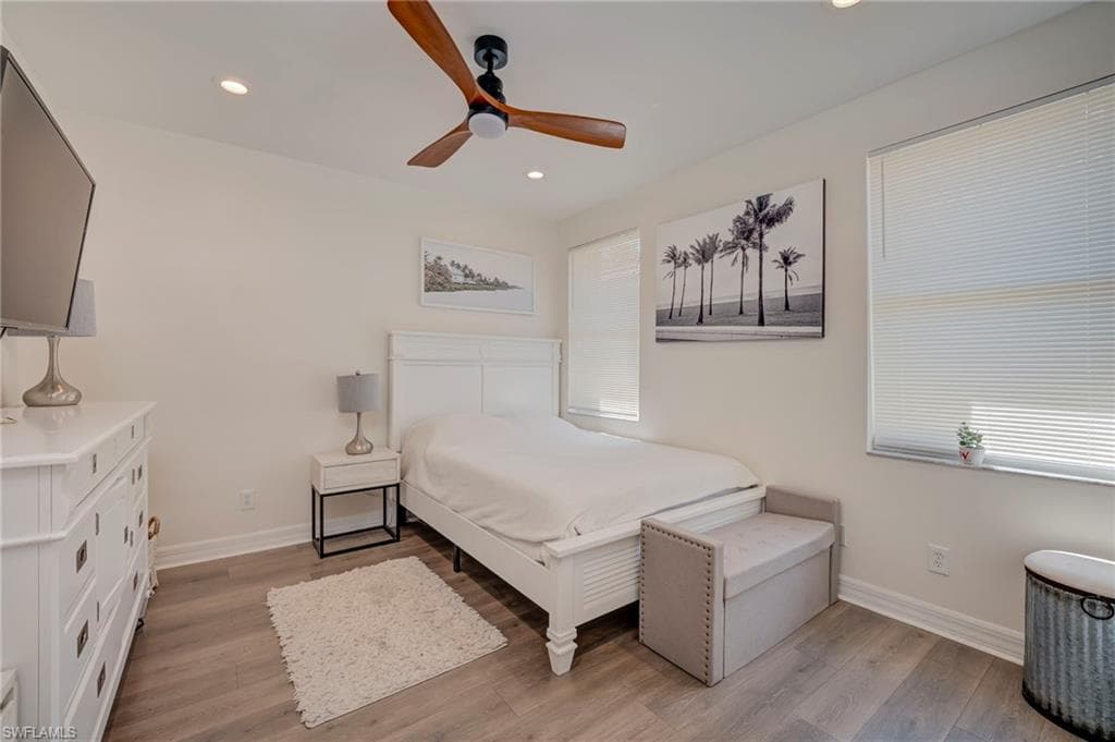 Bedroom featuring light wood finished floors, ceiling fan, and recessed lighting