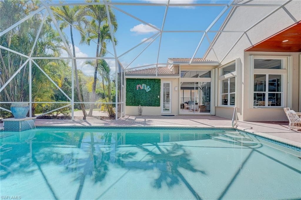 Swimming pool featuring enclosure and a patio area