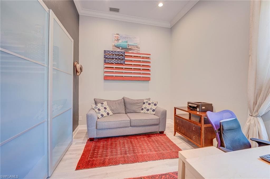 Office space featuring wood finished floors, crown molding, and recessed lighting