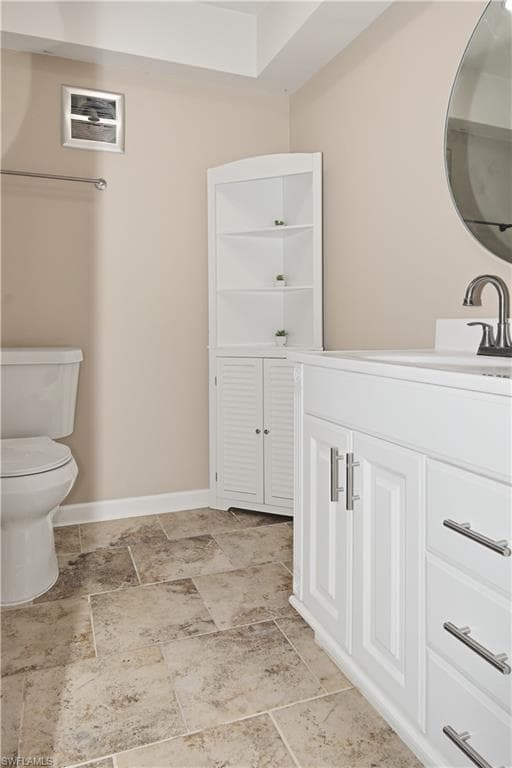 Bathroom with vanity and light stone finish flooring