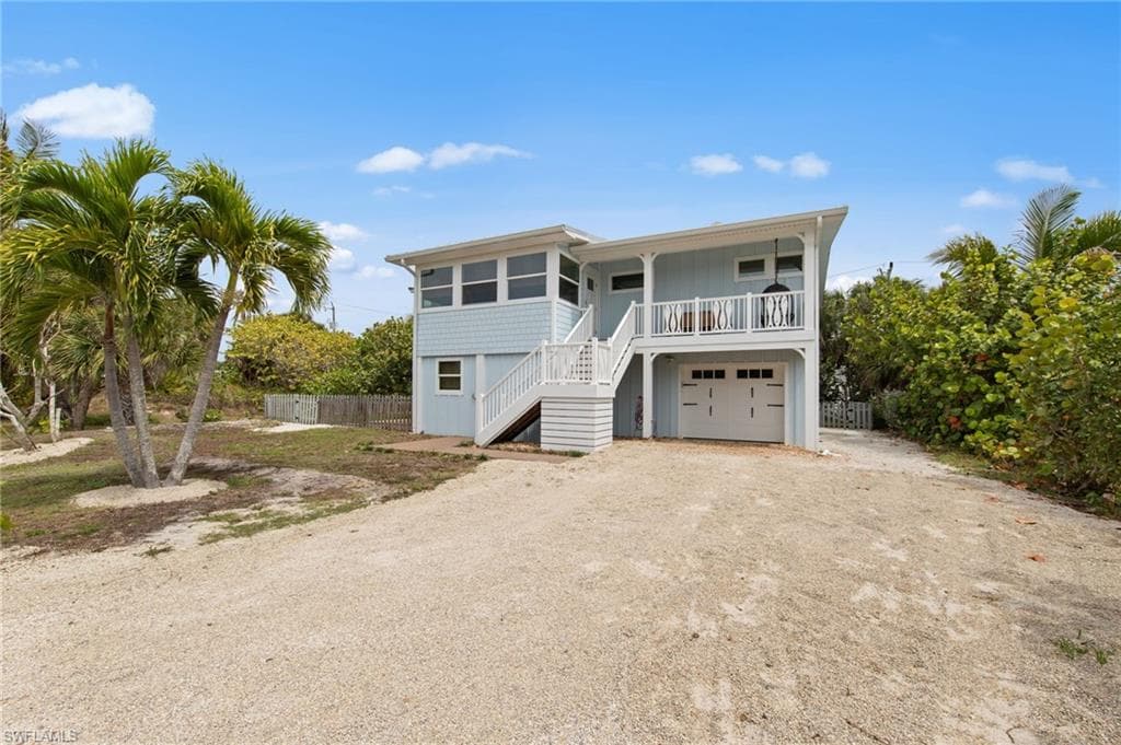 Coastal home with driveway and a garage