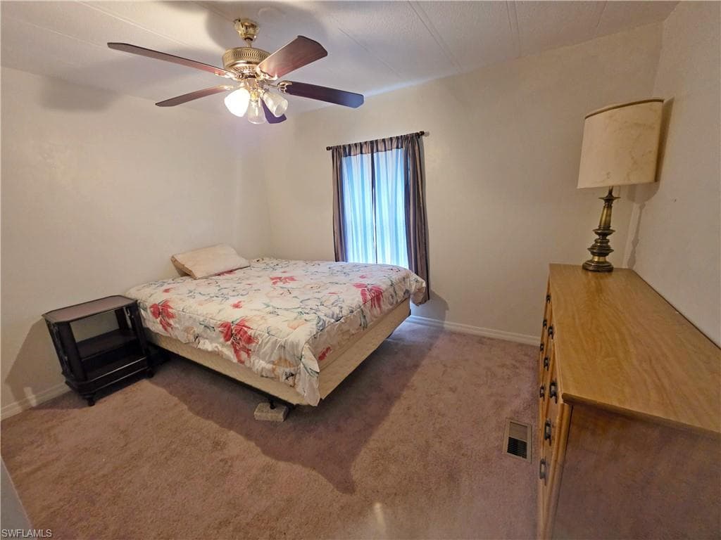 Bedroom featuring light carpet and ceiling fan