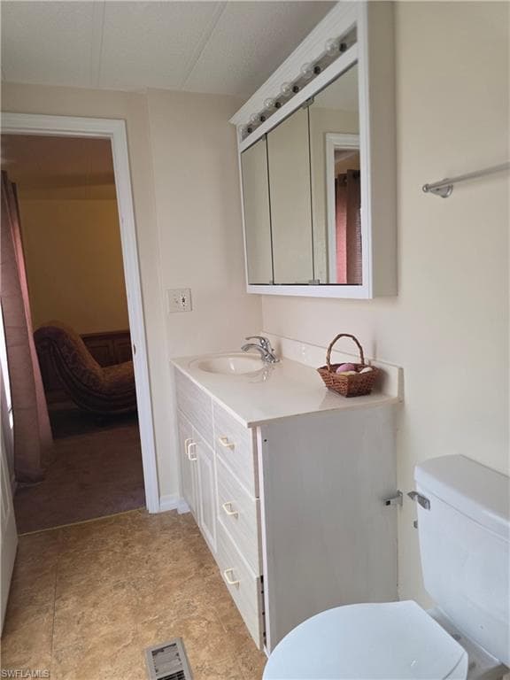 Half bathroom with vanity and ensuite bathroom