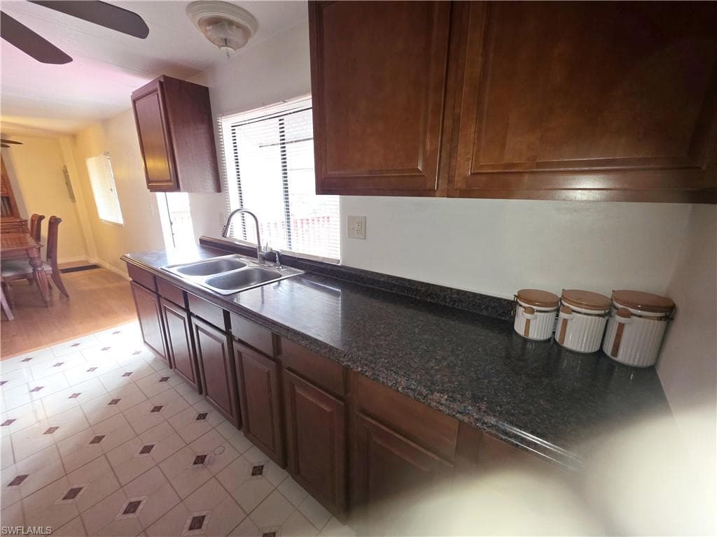 Kitchen with ceiling fan and light floors