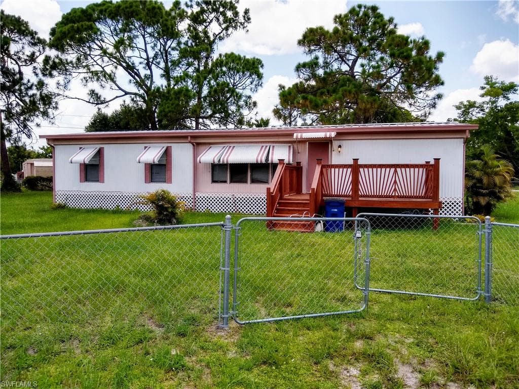 Manufactured / mobile home featuring a gate and a deck