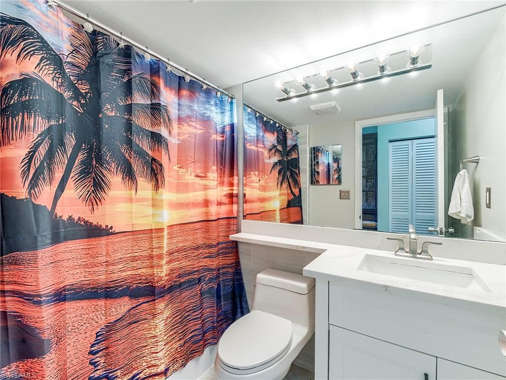 Bathroom with vanity and curtained shower