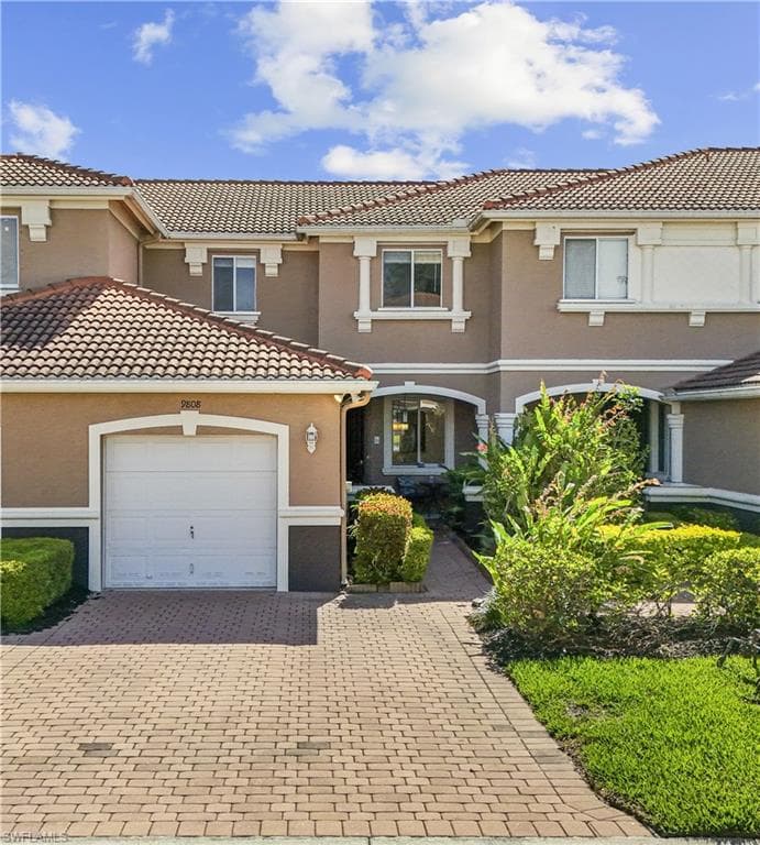 The property features a Mediterranean-style exterior with a tiled roof and stucco finish
