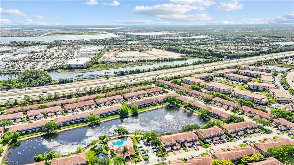 Aerial view showcasing the property's location within a community featuring water bodies and surrounding developments