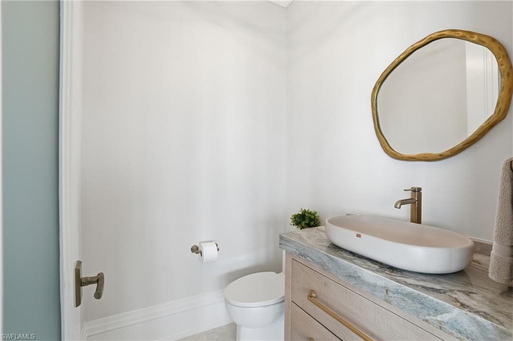 Half bathroom with toilet and vanity - Virtually Edited Image