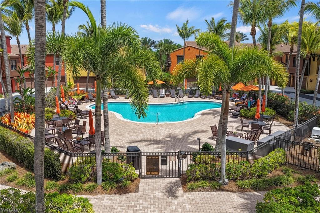 Community pool featuring a gate and a patio