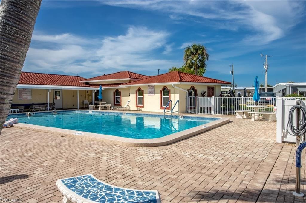 Community sakt water pool featuring a patio area