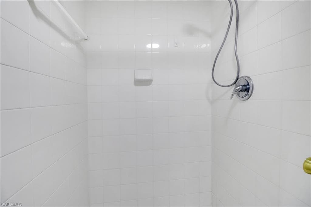 Room details featuring tiled shower