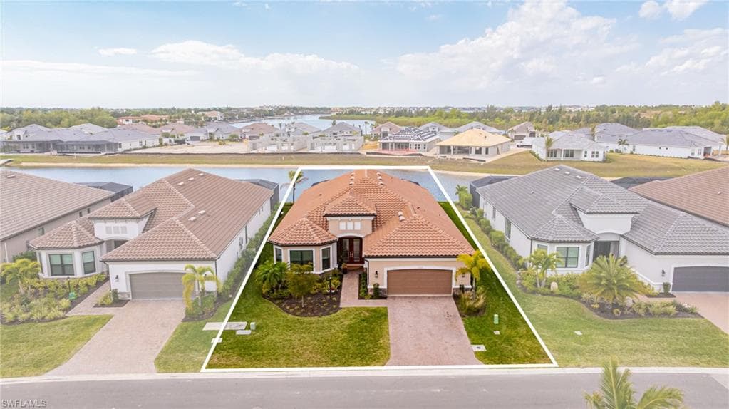 Aerial perspective of suburban area featuring a large body of water