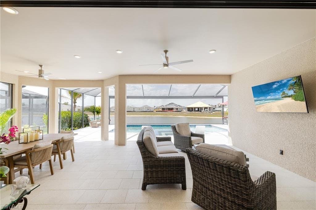 View of patio / terrace with a ceiling fan, a sunroom, an outdoor pool, and outdoor dining space