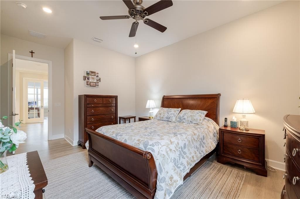 Bedroom with light wood-style flooring, a ceiling fan, and recessed lighting