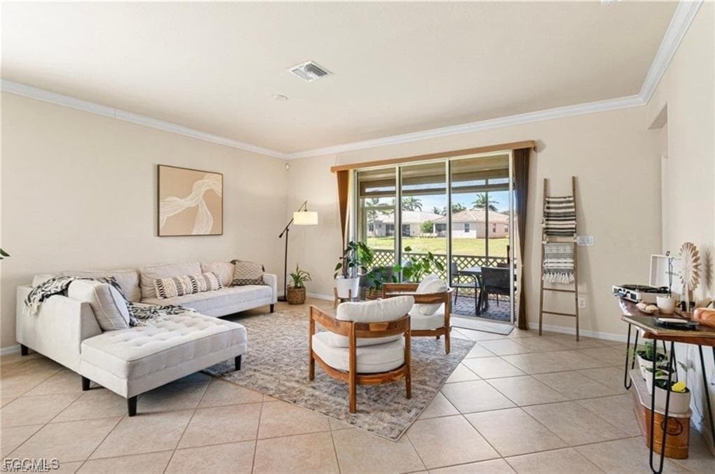 Living area with ornamental molding and light tile patterned floors