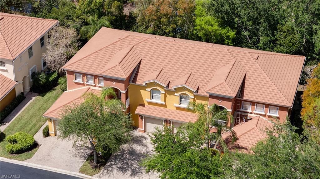View from above of property featuring a tree filled landscape