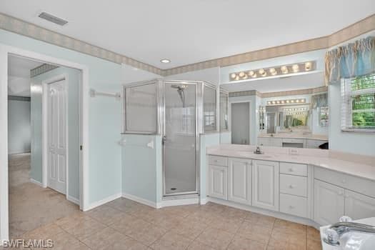 Owners' bath with double vanities, tile floors