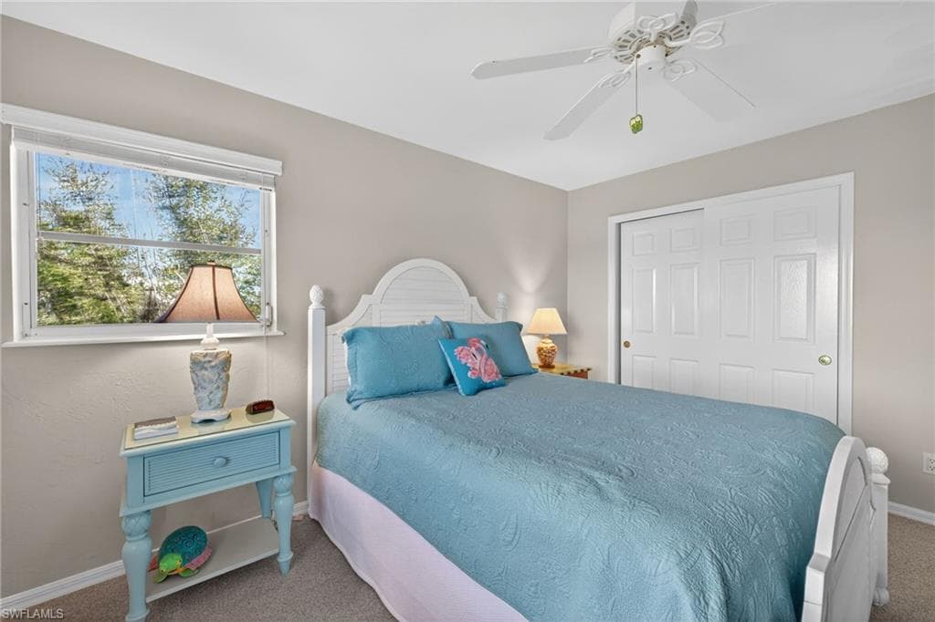 Bedroom with carpet, a closet, and ceiling fan