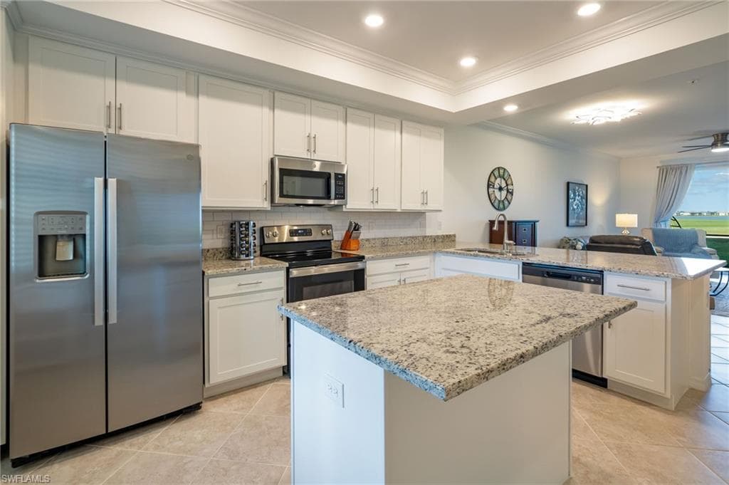 Stainless steel appliances and lovely backsplash create a modern, clean look.