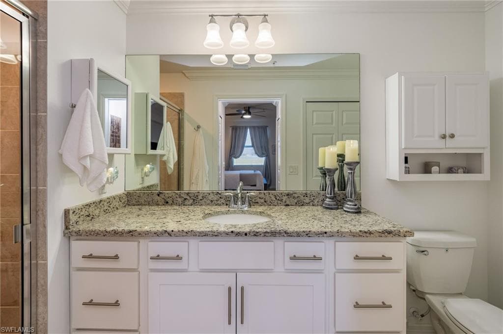 The Primary bathroom includes a walk-in shower and a large vanity with granite countertop.