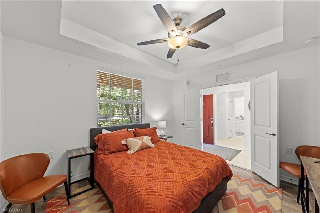 The property features a room with a tray ceiling and a ceiling fan