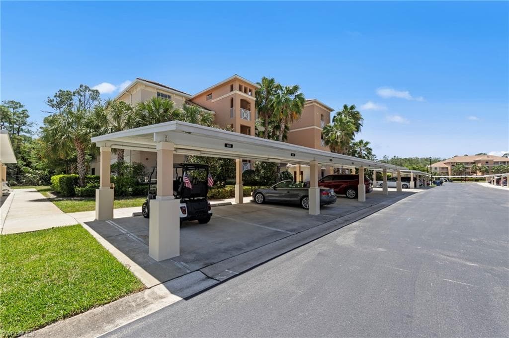 Covered parking spaces are available, with a paved driveway and landscaped grass areas