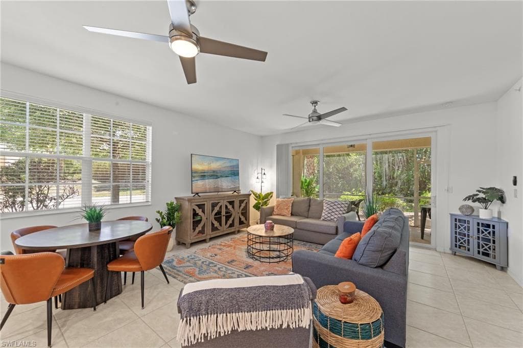 The property features an open living and dining area with light-colored tile flooring and white walls