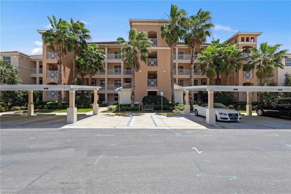 The property features a multi-story building with balconies and a tile roof