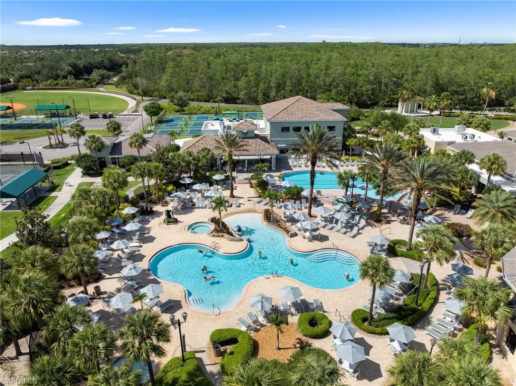 The community features a large outdoor pool with a sun shelf and a separate hot tub