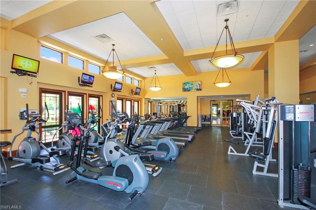 The property features a well-equipped fitness center with various exercise machines, including treadmills, elliptical trainers, and weight machines