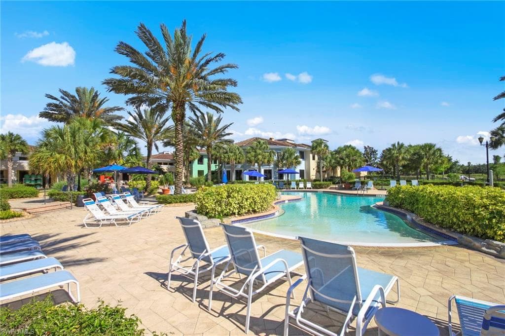 The property features a large outdoor pool with a spacious surrounding patio area
