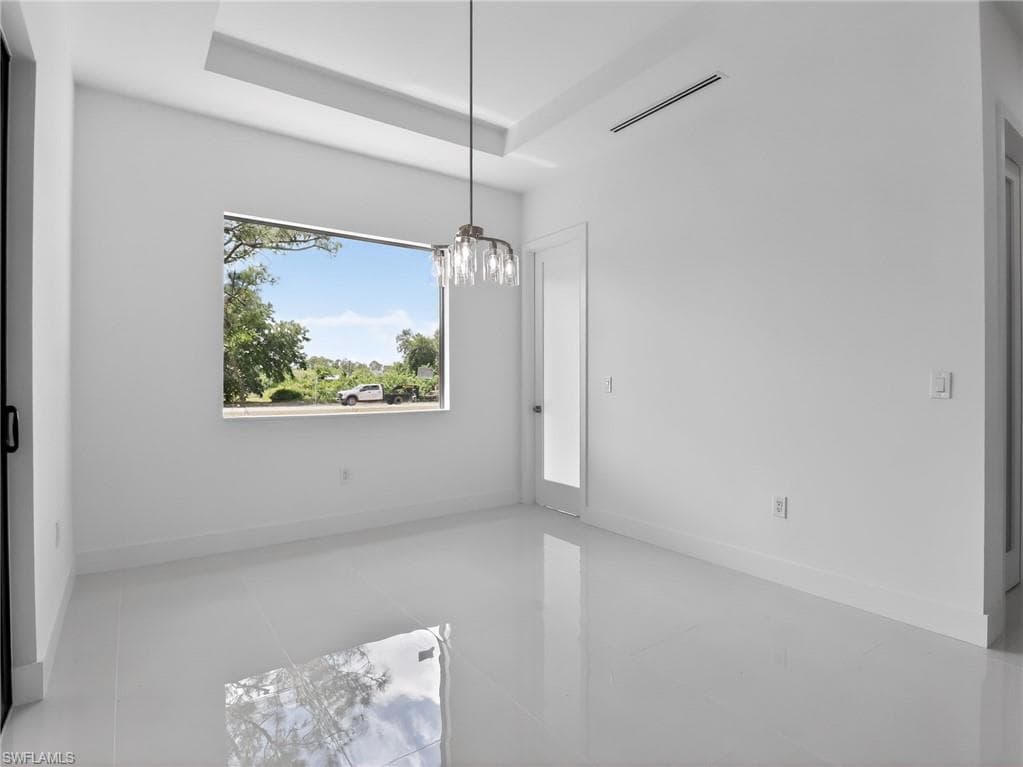 Room with white walls, a large window, and a modern light fixture