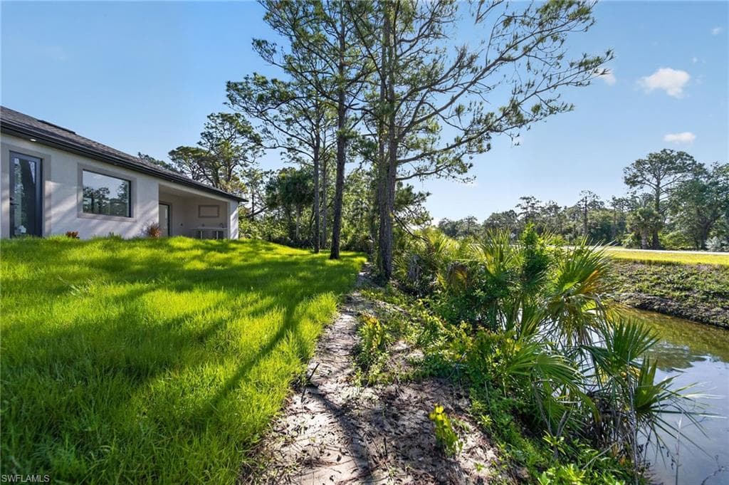 Expansive green lawn bordering a natural waterway