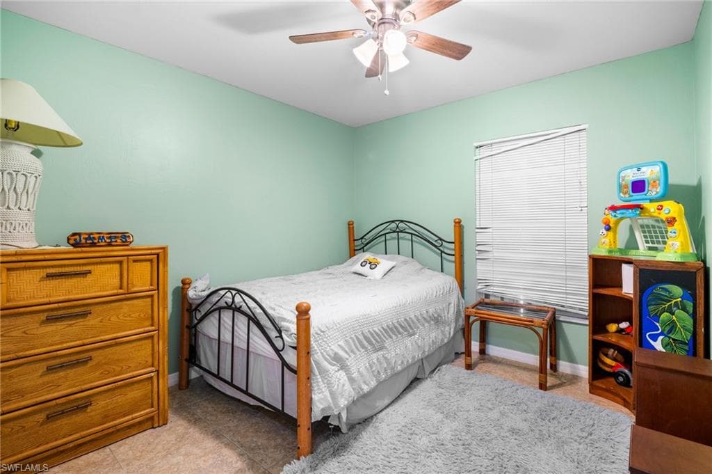 Bedroom with a ceiling fan and baseboards