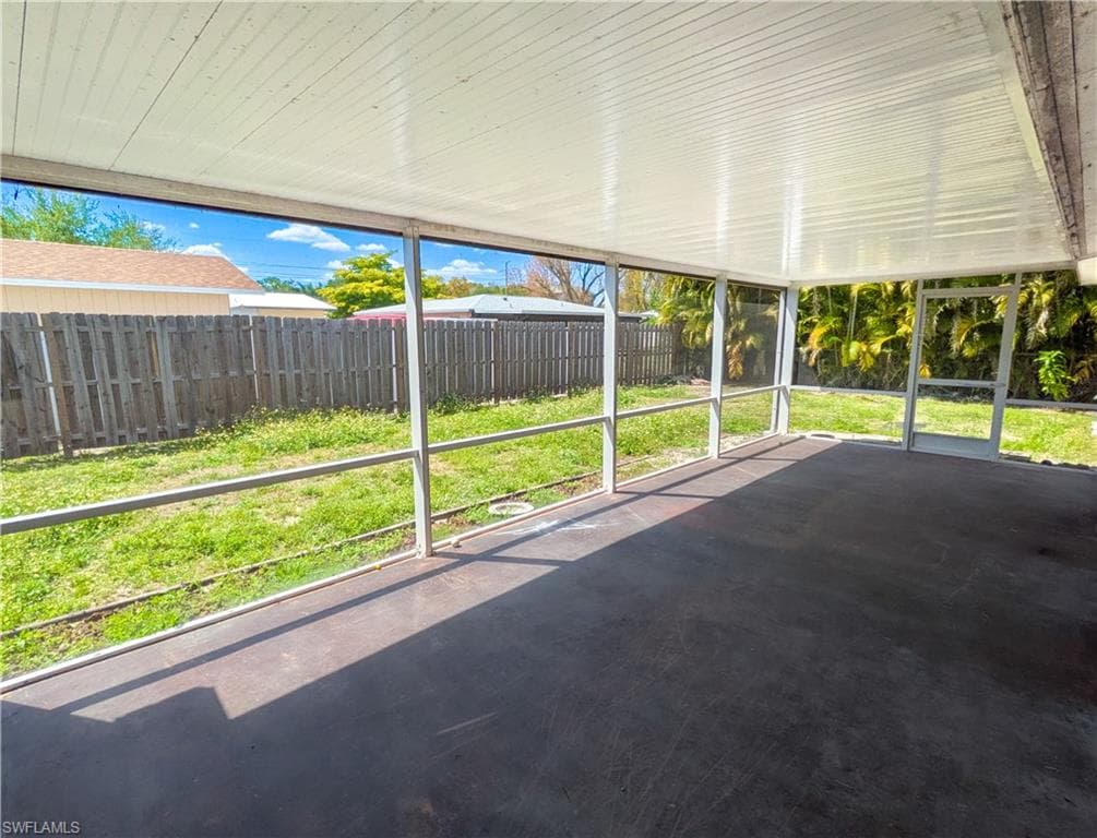 The property features a screened-in patio with a concrete floor and a white paneled ceiling