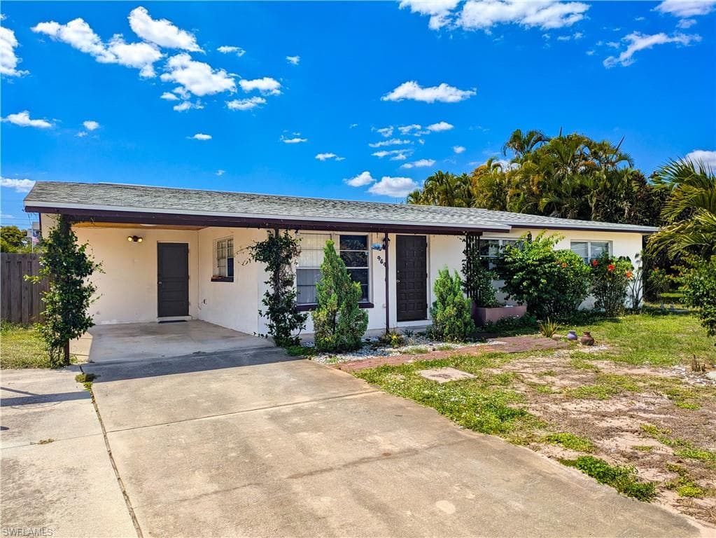 The property features a single-story design with a white exterior and a dark brown roof trim