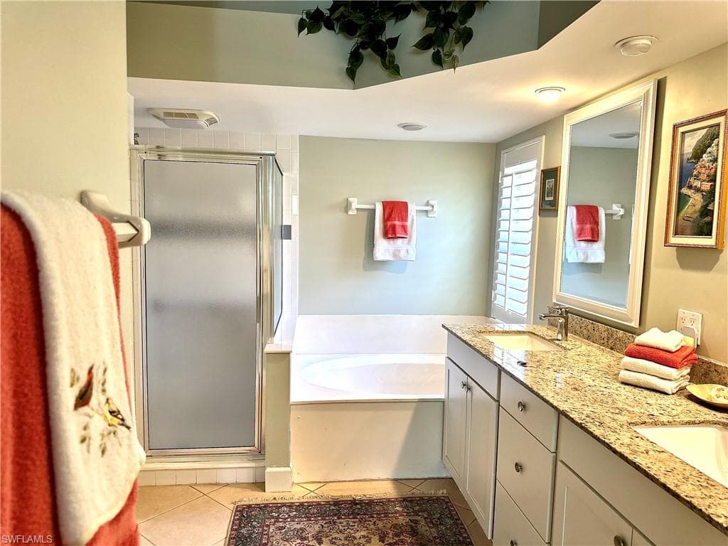The main en suite bath features a bath tub, a step in shower, and a water closet, for privacy.